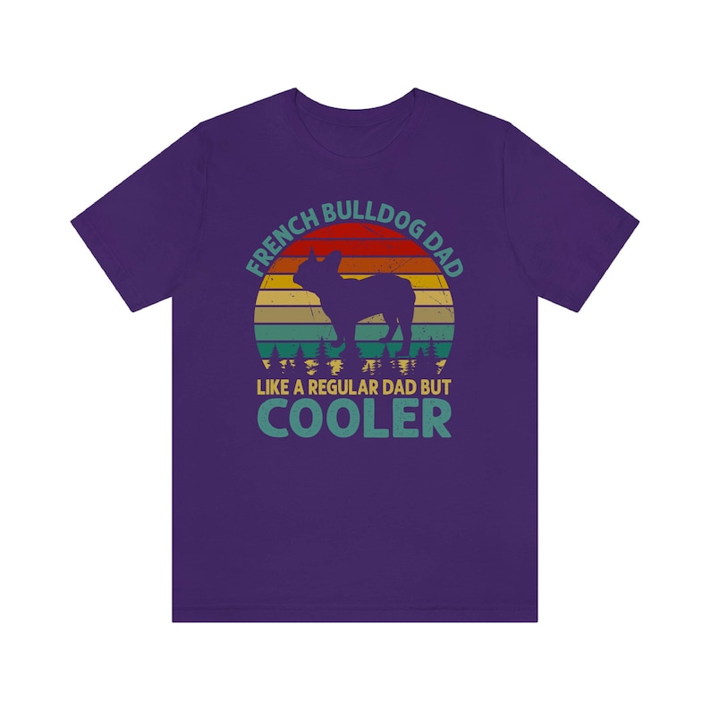 May include: Purple t-shirt with a vintage-style graphic of a French Bulldog. The graphic says "French Bulldog Dad Like a Regular Dad But Cooler".