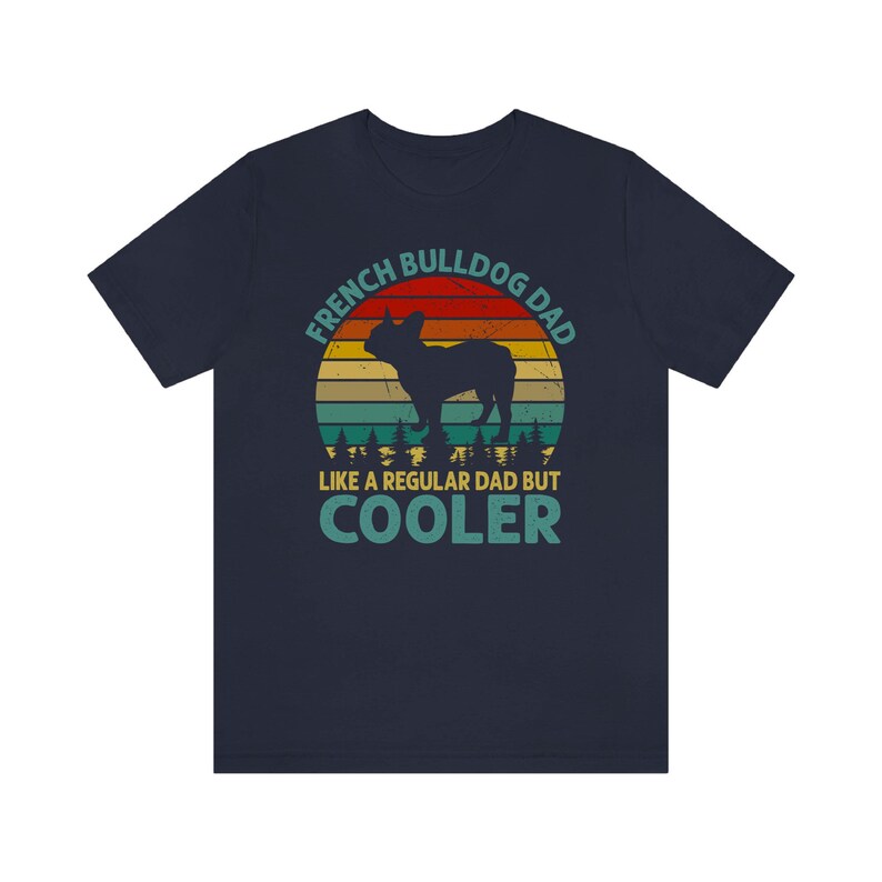 May include: Navy blue t-shirt with a vintage-style graphic of a French Bulldog. The graphic features a sunset background with the text "French Bulldog Dad Like a Regular Dad But Cooler".