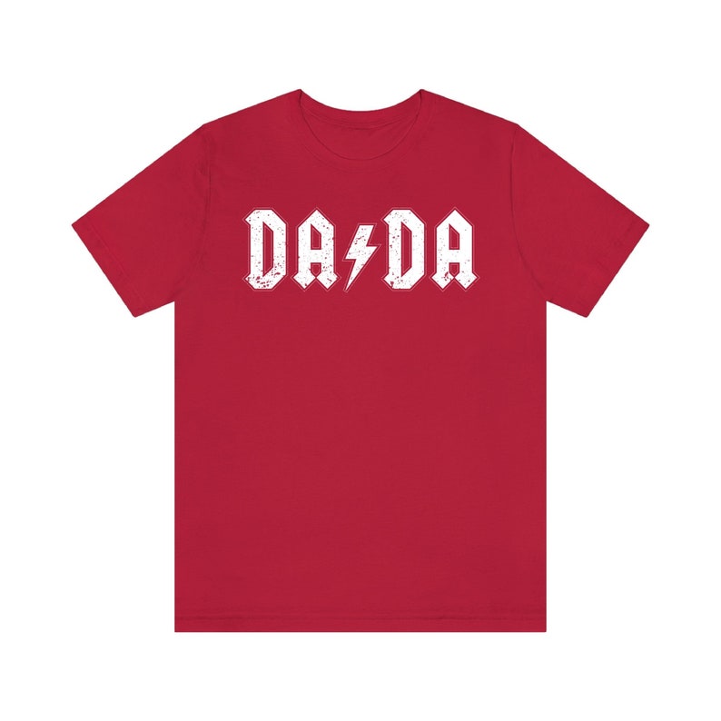 May include: Red t-shirt with a white graphic that says "DA DA" with a lightning bolt in between the words.