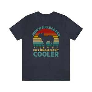 May include: A dark blue t-shirt with a vintage-style graphic of a French Bulldog in front of a sunset. The text reads "French Bulldog Dad Like a Regular Dad But Cooler".