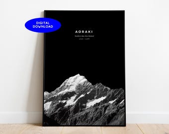 May include: Black and white framed print featuring a mountain range with snow-capped peaks. The word "AORAKI" is at the top, with "Southern Alps, New Zealand" below it. A blue oval with "DIGITAL DOWNLOAD" is in the upper left corner.