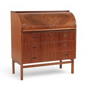 May include: A mid-century modern wooden desk with a roll-top and three drawers. The desk is made of a warm-toned wood with a patterned design on the roll-top. The drawers have recessed handles and the desk sits on four legs.