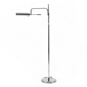 May include: A modern, chrome-finished floor lamp with a cylindrical light fixture. The lamp has a tall, slender pole and a circular base. The light fixture extends horizontally and is adjustable. The lamp is designed for indoor use.