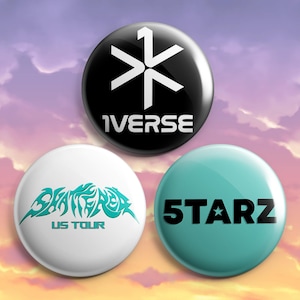 May include: Three round button pins. The top pin is black with a white starburst design and the word "1VERSE". The bottom left pin is white with teal text that says "SHATTERED US TOUR". The bottom right pin is teal with "5 STARZ".