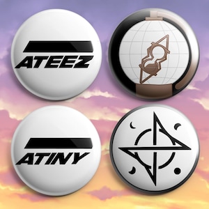 May include: Four white round buttons with black designs. Two buttons have the text "ATEEZ" and "ATINY". The other two buttons have a brown hourglass design on a globe and a black geometric design.