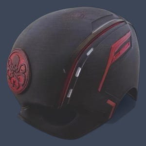 May include: A black helmet with red and white stripes and a red Hydra logo. The helmet is made of a textured material and has a slightly worn look.
