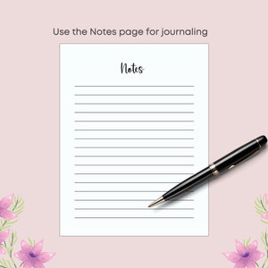May include: A white lined notepad with the word "Notes" in cursive, and the text "Use the Notes page for journaling". A black pen rests on the notepad. The background is a light pink with purple floral accents.
