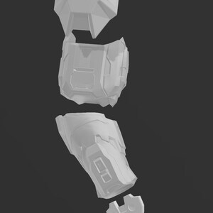 May include: A white plastic model of a robotic arm, separated into five pieces. The pieces are designed to be assembled together to create a complete arm.