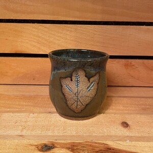 8 oz handmade pottery cup with carved nature design