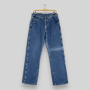 May include: A pair of blue denim jeans hanging on a wooden hanger. The jeans have a classic straight leg style and are made of a soft, comfortable fabric.