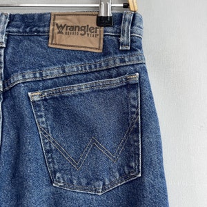 May include: A pair of blue denim jeans with a back pocket featuring a stitched