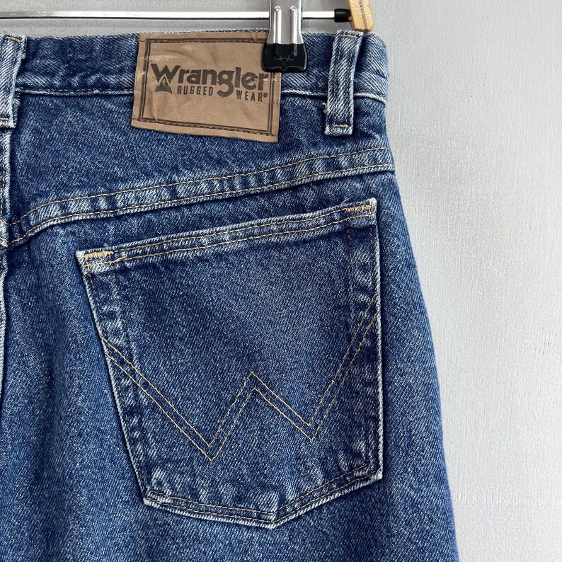 May include: A pair of blue denim jeans with a back pocket featuring a stitched