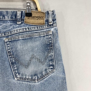 May include: A pair of light blue denim jeans with a back pocket featuring a distinctive