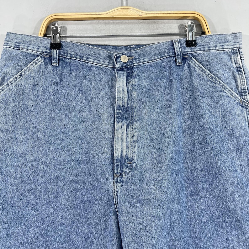 K&ouml;nnte beinhalten: Eine hellblaue Jeanshose mit Knopfleiste und zwei Vordertaschen.
