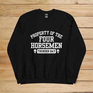 May include: Black sweatshirt with white text that reads "Property of the Four Horsemen Thunder Bay" with two skull graphics.