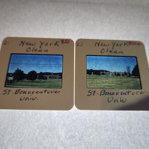 May include: Two vintage 35mm slides of St. Bonaventure University in Olean, New York. The slides are in brown plastic frames with handwritten labels.