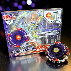 May include: A boxed Gaia Dragoon M2 Benchblade toy set. The box features a dragon illustration with the text "Heavy Metal System" and "Full Metal Version." A purple and orange toy is next to the box.
