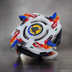May include: White and red Beyblade with a dragon design on the center. The Beyblade has a black base and blue and orange accents.