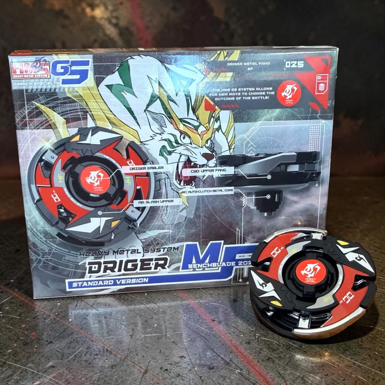 May include: A boxed toy set featuring a black, red, and gold spinning top with a matching launcher. The box has a tiger illustration and text that reads "DRIGER" and "Heavy Metal System". A second spinning top is visible.