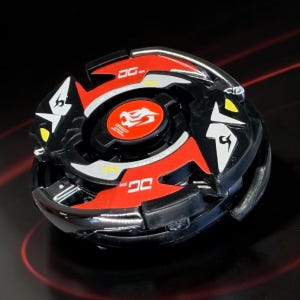 May include: A black and red spinning top toy with silver accents. The toy features a circular design with red and black sections, white and yellow details, and the text "DG" on the red sections. The center has a red emblem with a dragon.