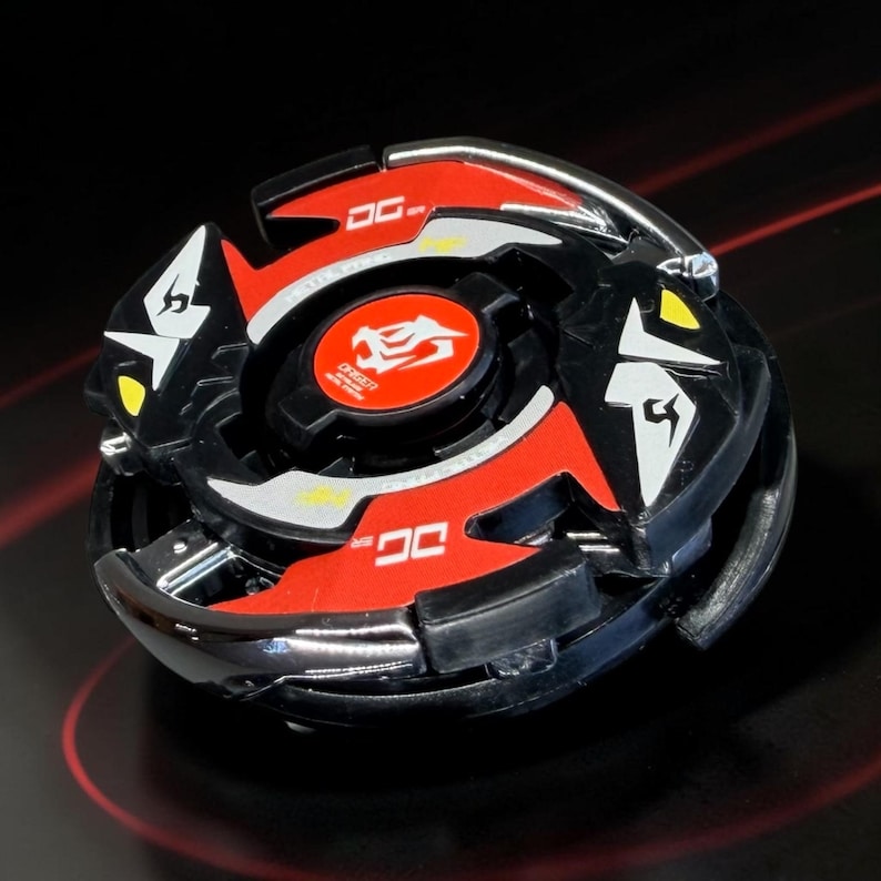 May include: A black and red spinning top toy with silver accents. The toy features a circular design with red and black sections, white and yellow details, and the text "DG" on the red sections. The center has a red emblem with a dragon.