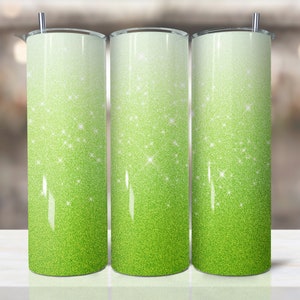 May include: Three stainless steel tumblers with a green glitter ombre design. The tumblers have a white top that fades to a bright green at the bottom.