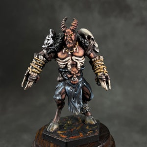 May include: A painted miniature figurine of a demonic creature with horns, a skeletal ribcage, and a fur-lined cloak. The figure is standing on a black and orange base.