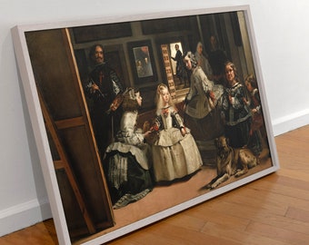 May include: A framed print of Diego Velázquez's Las Meninas, featuring a central young girl in a white dress surrounded by attendants, a dog, and a painter in a dark room with a mirror on the back wall, all enclosed in a light-colored wooden frame.