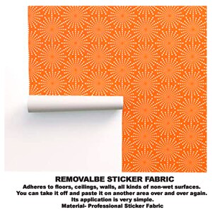 May include: Orange and white removable sticker fabric with a repeating pattern of white circles with radiating lines. The text "REMOVALBE STICKER FABRIC" is at the bottom of the image. "Adheres to floors, ceilings, walls, all kinds of non-wet surfaces. You can take it off and paste it on another area over and over again. Its application is very simple. Material- Professional Sticker Fabric."