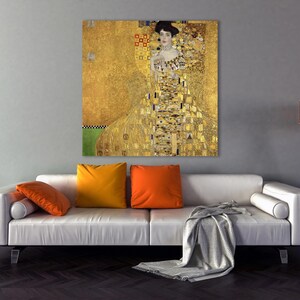 May include: A painting of a woman in a gold dress with a geometric pattern. The background is also gold with a geometric pattern.