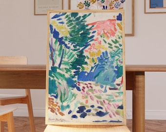 May include: A colorful abstract painting of a landscape with green, blue, pink, and yellow hues. The painting is framed and hanging on a wall in a dining room setting.