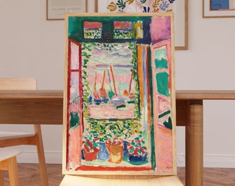 May include: A colorful painting of a window with a view of boats on the water. The window is framed in pink and green, and the boats are painted in shades of pink, blue, and yellow. The painting is hanging on a wall in a room with a wooden table and chairs.