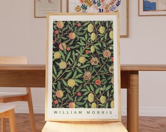 May include: A framed print of a vintage botanical illustration featuring a leafy branch with lemons, pomegranates, and flowers on a dark background. The print is titled "William Morris".