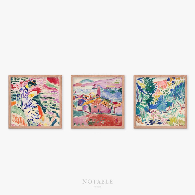May include: Three framed paintings with abstract landscapes in bright colors, including pink, blue, green, and yellow. The paintings are in wooden frames with a light brown finish.