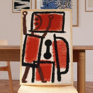 Puede incluir: Una pintura abstracta enmarcada con un esquema de color rojo, negro y blanco. La pintura presenta formas geométricas y líneas, creando una composición dinámica y abstracta.