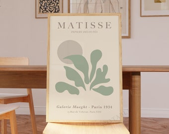 May include: A beige and green abstract art print with the text "MATISSE - PAPIERS DECOUPES" and "Galerie Maeght - Paris 1934" and "15 Rue de Téhéran, Paris VIII".