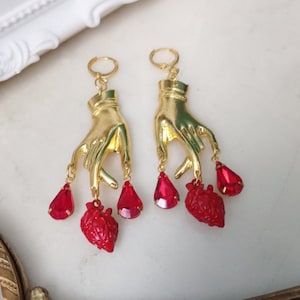Trust Me Darling – Mystical statement earrings | Golden hands with ruby hearts | Gothic jewelry | Magical jewelry | Baroque style