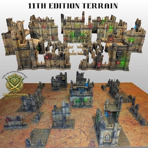 May include: A collection of 11th Edition Terrain pieces for tabletop gaming, featuring weathered stone-coloured gothic ruins with intricate architectural details, arched windows, and small embedded red, green, and blue light-up indicators.