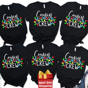 May include: Six black short-sleeved t-shirts arranged in two rows, each featuring the white text "Cousin CREW" above a graphic of colorful Christmas light bulbs. The shirts have a crew neckline and a standard fit, displaying a festive holiday design.
