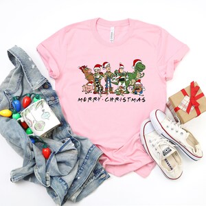 a pink t - shirt with the words merry christmas on it