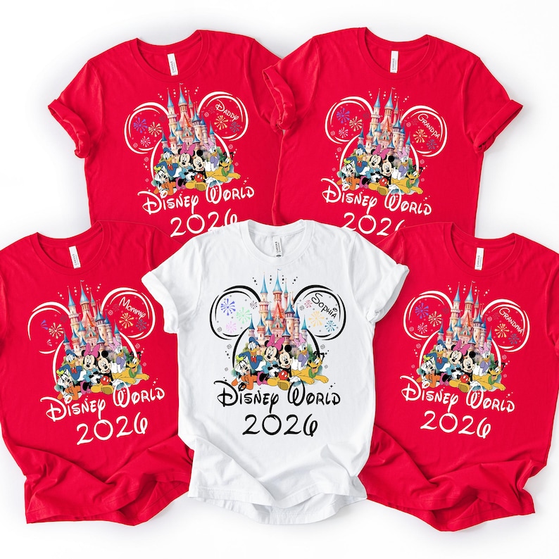 May include: Five t-shirts, four red and one white, featuring a Disney World 2026 design. The design includes a castle, Disney characters, and the text "Disney World 2026". Some shirts have additional text like "Mommy", "Daddy", "Grandma", and "Sophia".