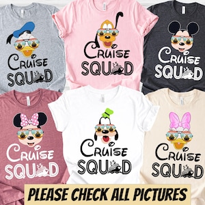 May include: A collection of colorful t-shirts featuring cartoon characters wearing sunglasses. Each shirt has the words "Cruise Squad" and a cruise ship graphic. The shirts are in various colors, including gray, pink, white, and burgundy.