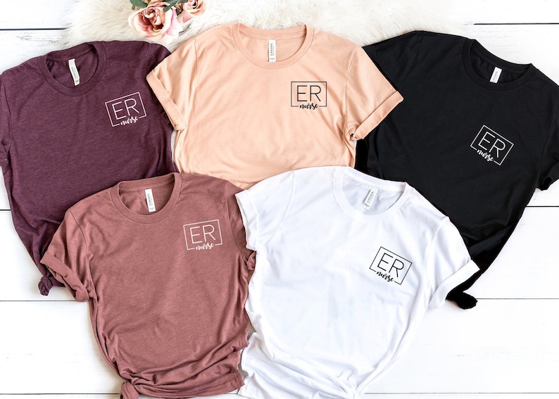 May include: Five t-shirts in different colors with the text "ER nurse" in a black square on the front.