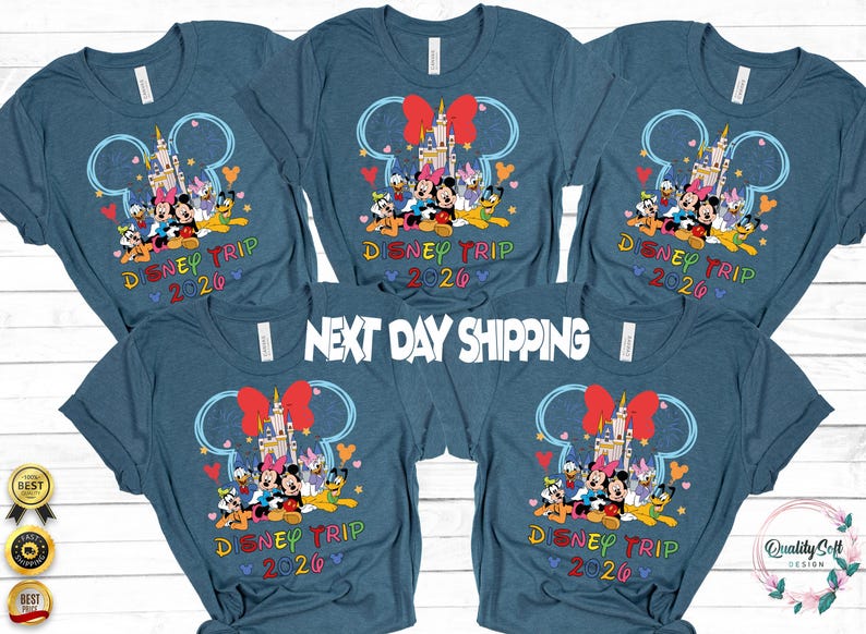 May include: Blue t-shirts with a Disney Trip 2020 design. The graphic features Mickey Mouse, Minnie Mouse, Donald Duck, and other characters in front of a castle. The text "NEXT DAY SHIPPING" is also visible.