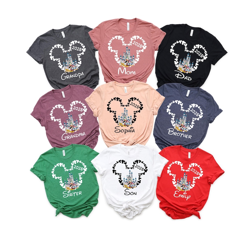 May include: Nine different t-shirts featuring a white Mickey Mouse head outline with a picture of Cinderella's castle inside. Each shirt has a different name printed on it, including "Grandpa", "Mom", "Dad", "Grandma", "Sophia", "Brother", "Sister", "Son", and "Emily".