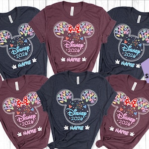 a collection of Disney-themed t-shirts, each featuring a unique design with Mickey Mouse ears and colorful decorations. The t-shirts are arranged in a grid pattern, showcasing various sizes and styles. The text on the t-shirts reads "Disney 2020" and "NAME", indicating that these are personalized t-shirts for Disney's 2020 event.