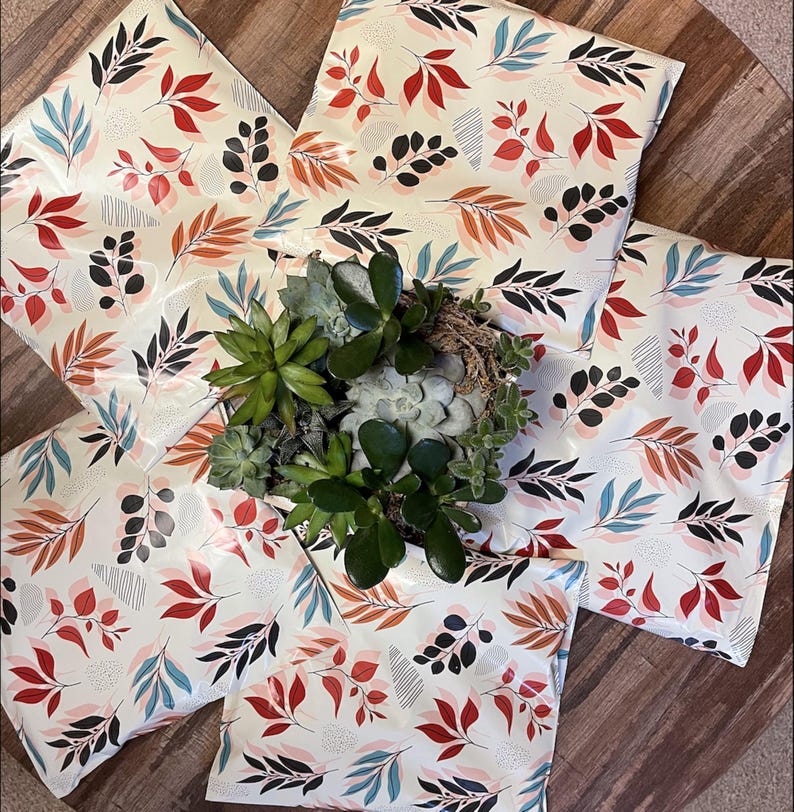 May include: A white ceramic mug with a black handle and the text "But First, Coffee" in a bold, black font. The mug is set against a blurred background, suggesting a cozy setting.