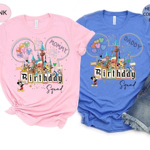 May include: Pink and blue t-shirts with a colorful graphic featuring a castle, balloons, and cartoon characters. The pink shirt says "Mommy Birthday Squad" and the blue shirt says "Daddy Birthday Squad".