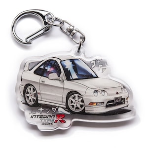 May include: White Honda Integra Type R keychain with a cartoon illustration of the car. The keychain is made of clear acrylic and has a silver metal key ring.