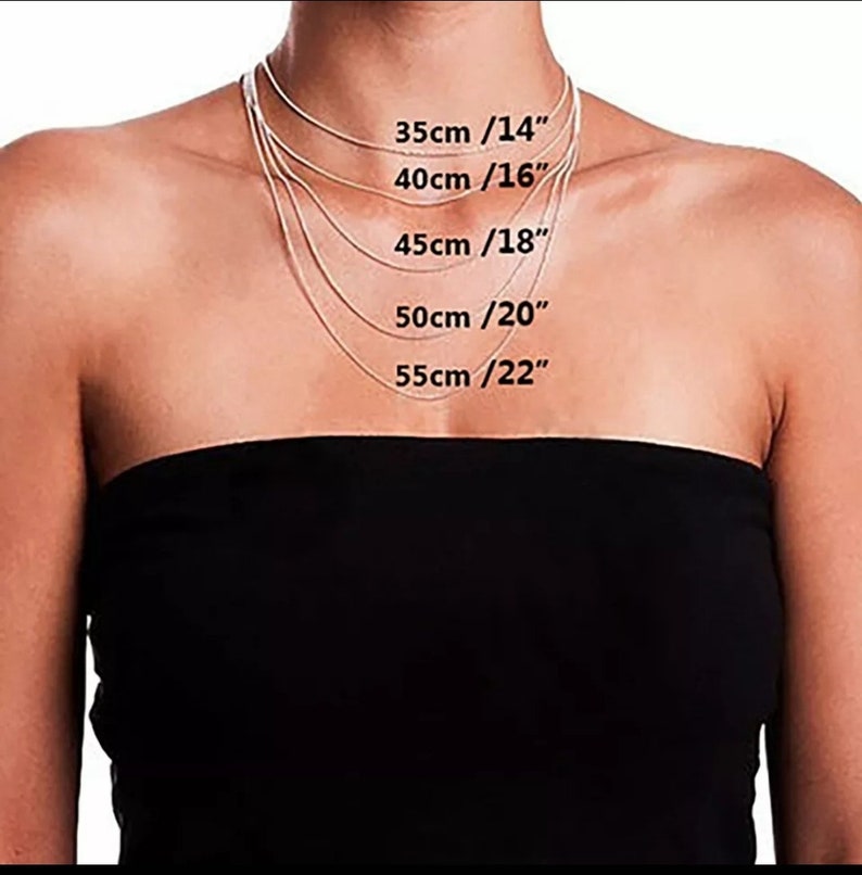 May include: A model wears a silver chain necklace in five different lengths, with measurements in inches and centimetres labelled on the image. The lengths are 14 inches (35 cm), 16 inches (40 cm), 18 inches (45 cm), 20 inches (50 cm), and 22 inches (55 cm).